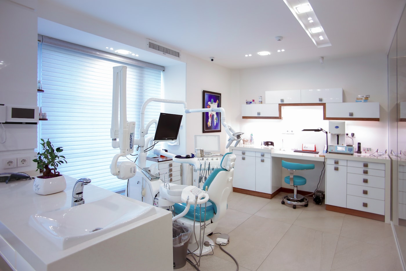 Bright modern dental operatory with a teal chair