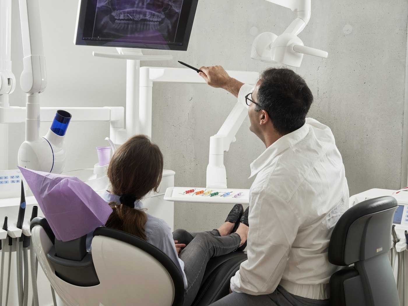 Dentist showing a patient their x-ray on screen